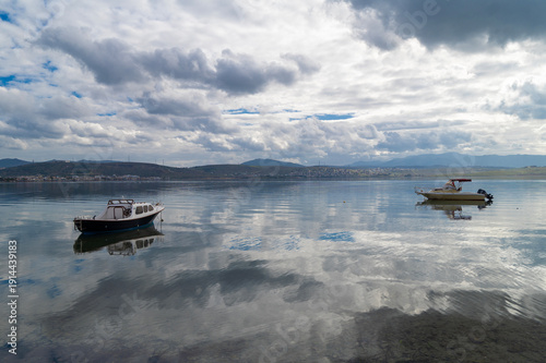 Wallpaper Mural With calm, reflective sea and boats and cloudy sky Torontodigital.ca