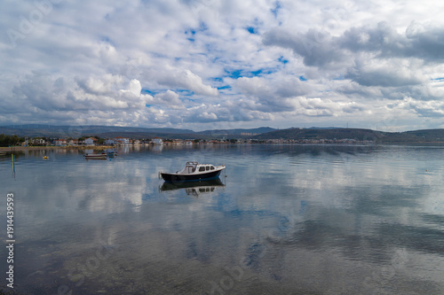 Wallpaper Mural With calm, reflective sea and boats and cloudy sky Torontodigital.ca