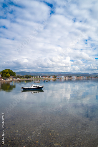 Wallpaper Mural With calm, reflective sea and boats and cloudy sky Torontodigital.ca