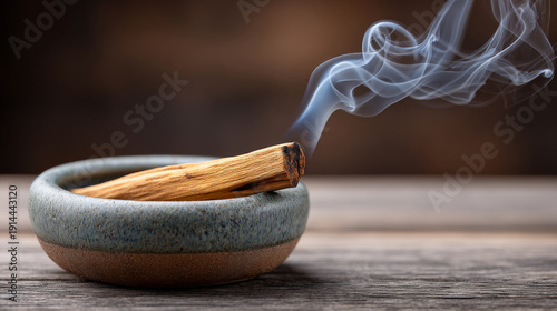 Tranquil aromatherapy with burning palo santo stick in ceramic holder for relaxation and meditation