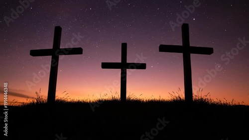 Three crosses silhouetted on a hill during a time lapse from a vibrant sunset to a starry night sky. Christian concept of the crucifixion of jesus for easter and good friday