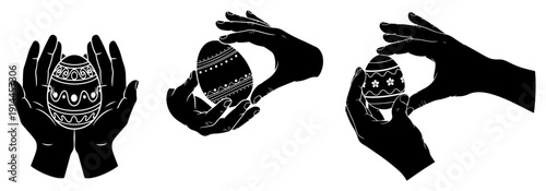 Black silhouettes of hands holding beautifully decorated Easter eggs