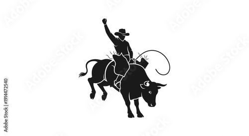 Silhouette of Cowboy Riding a Bull with Lasso at Sunset