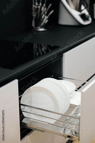 Modern luxury kitchen interior with beige cabinets and navy blue island.