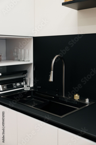 Modern luxury kitchen interior with beige cabinets and navy blue island.