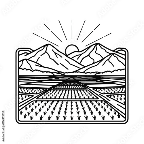 Mountain range landscape with sun rising over field and crops