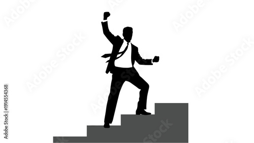 A triumphant businessman in a suit standing on stairs with his fist raised in victory