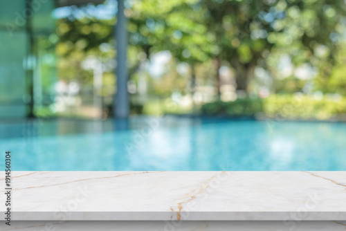 Cuadro en lienzo Empty marble table top with blur outdoor swimming pool in tropical resort hotel