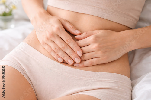 Woman hand on belly pain polycystic ovary syndrome concept on bed woman hand belly pain polycystic ovary syndrome health female