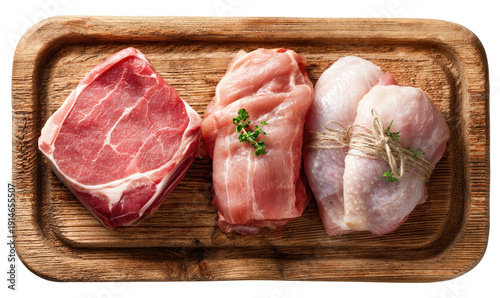 Assorted raw meats neatly presented on wooden board, ready for cooking