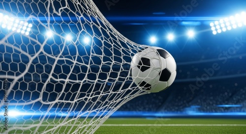 Action shot of a soccer ball hitting the back of the net during a night match in a brightly lit professional stadium, symbolizing a goal and victory.