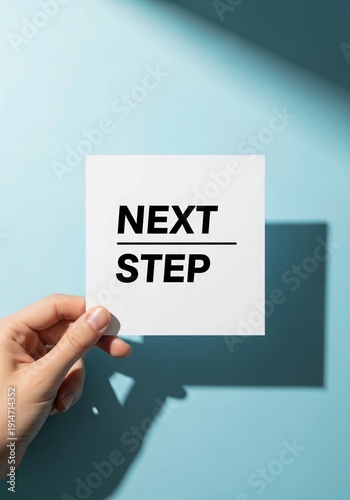 Hand holding white card with 