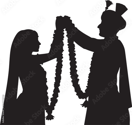 Silhouette of couple exchanging flower garlands exchange