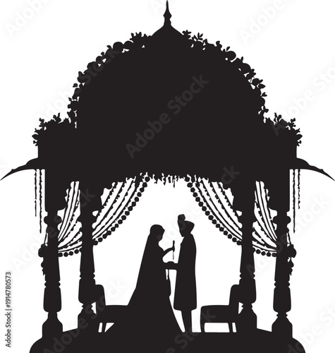 Silhouette of couple under decorated wedding canopy with floral arch