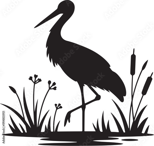 Black silhouette of a stork standing in water with reeds and flowers