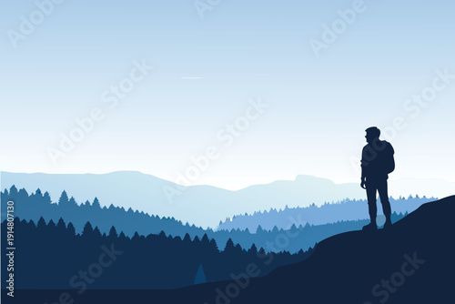 A lone figure with a backpack stands silhouetted against a mountainous landscape