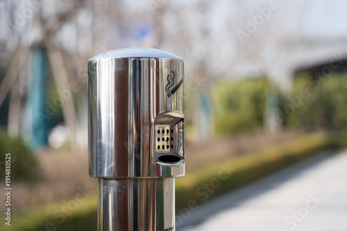 Canvastavla Stainless steel outdoor ashtray column in close-up with blurred background