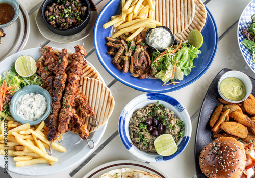 Wallpaper Mural many different mediterranean food dishes on restaurant table in greece Torontodigital.ca