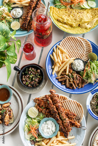 Wallpaper Mural many different mediterranean food dishes on restaurant table in greece Torontodigital.ca