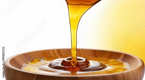 Close-up of honey pouring into a wooden bowl, with droplets around it. A warm, natural composition suitable for culinary, wellness, and eco-friendly projects.