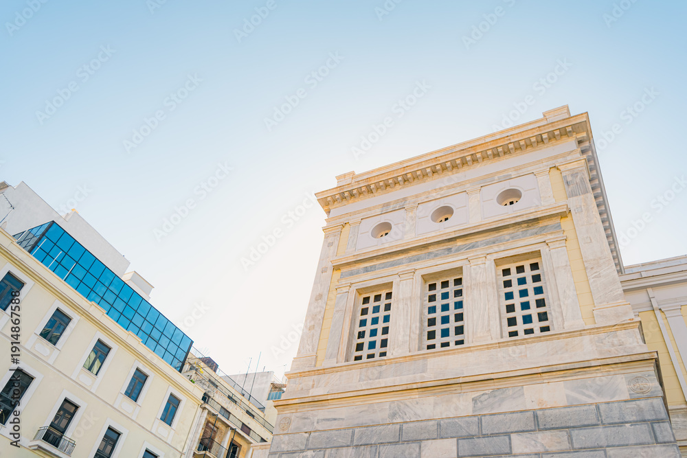Fototapeta premium Classical Limestone Building Meets Modern Glass Facade, Low Angle