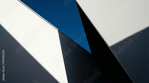 Geometric abstract composition with blue triangle and white angular shapes architectural detail