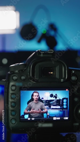 Tech influencer shooting video with photo camera