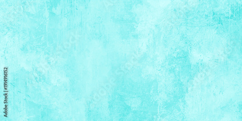 A vintage light blue grunge background featuring a textured paint pattern on an old rough wall material with an aged green paper parchment design for a blank artistic backdrop