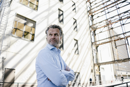 Wallpaper Mural Portrait of mature man looking back, arms crossed Torontodigital.ca
