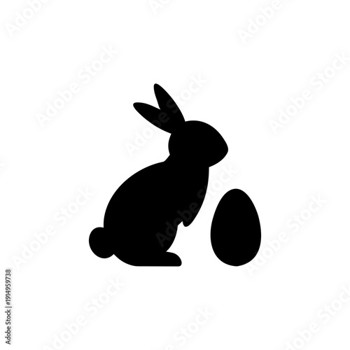 Solid black rabbit holding fresh carrot simple easter symbol Vector illustration