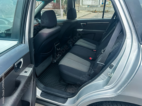 Wallpaper Mural Interior view of a silver vehicle showing the backseat area with clean seats and floor mat in a parking setting during daylight Torontodigital.ca