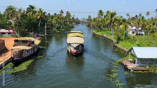 Traditional houseboats cruising through the backwaters of Kerala, India