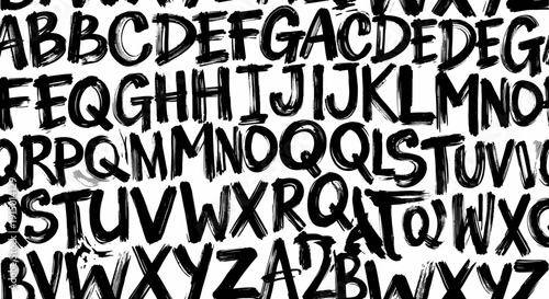 Abstract pattern of hand-drawn black uppercase letters on a white background, creating a chaotic texture.