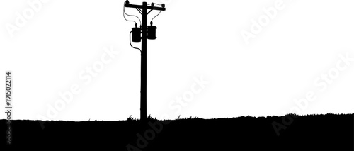 Electrical pole with transformers silhouette in rural field
