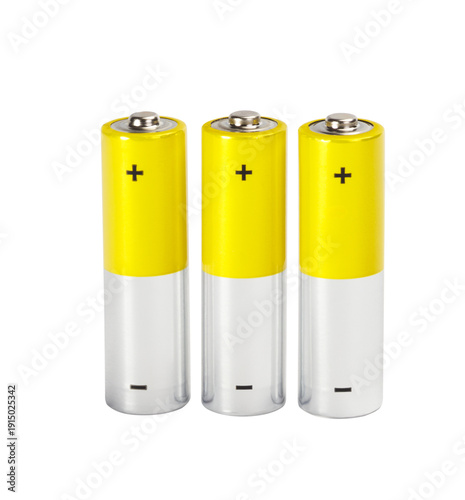 Fotografía Three yellow-silver AA alkaline batteries with plus and minus signs stand vertically next to each other on transparent  white background