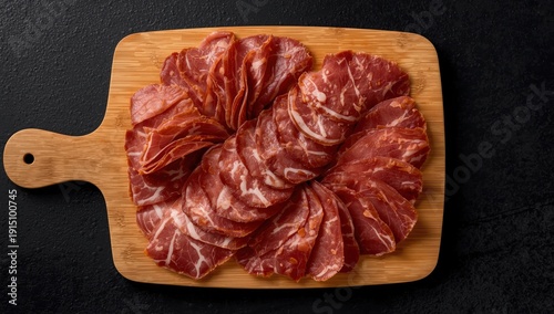 Wallpaper Mural Sliced Italian cooked ham on a cutting board, viewed from above against a dark background Torontodigital.ca