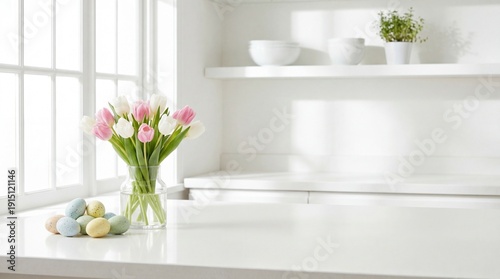 White kitchen countertop near a window with a glass vase of pink and white tulips and a bowl of pastel Easter eggs, minimalist spring decor with copy space.