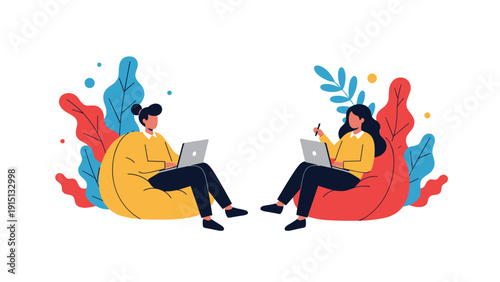 Two creative female professionals work on laptops while sitting comfortably in colorful bean bag chairs in modern office.