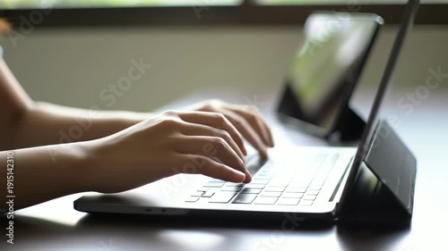 Person Typing on Laptop Keyboard.