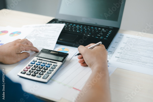 Billede på lærred Business professional calculating tax return with financial documents, laptop and calculator
