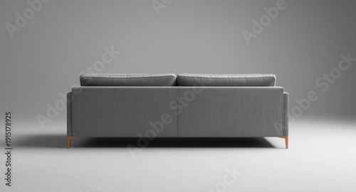 Modern sofa in gray captured from the rear in professional studio