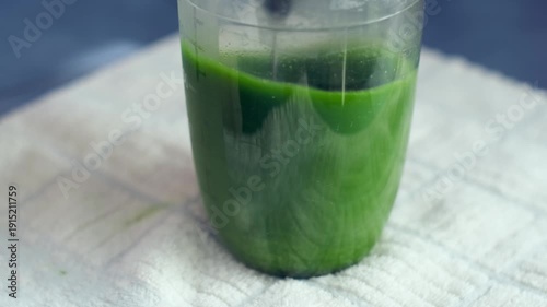 Electric milk frother stirring matcha green tea in a plastic cup creating a motor whirring and rattling sound