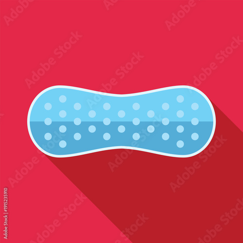Blue oblong textured sponge with white dots, casting a long shadow on a red background