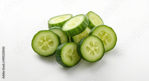 Crisp fresh cucumber rounds placed on a white backdrop for culinary themes
