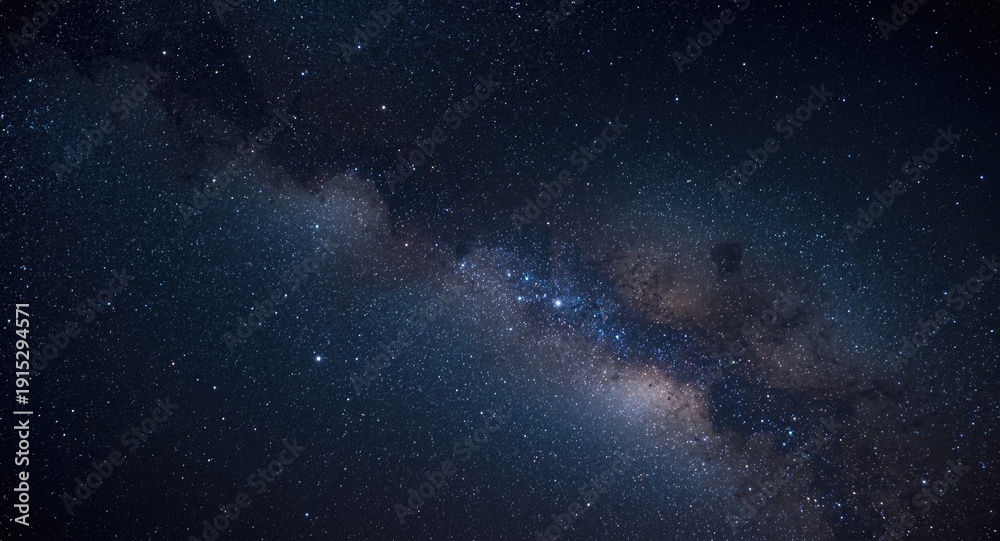 Fototapeta premium A sweeping panorama capturing the night sky studded with sparkling stars and intricate nebulae