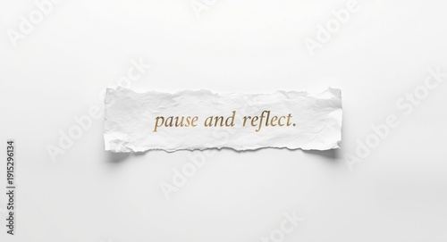 White surface featuring torn paper placed centrally with pause and reflect text