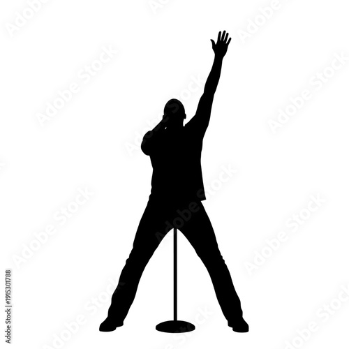 Silhouette of a man singing passionately into a microphone on stage.