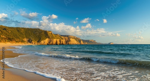 Calm sea waves and sunlit c...