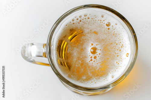 A close-up of a glass mug filled with beer, with a white background.