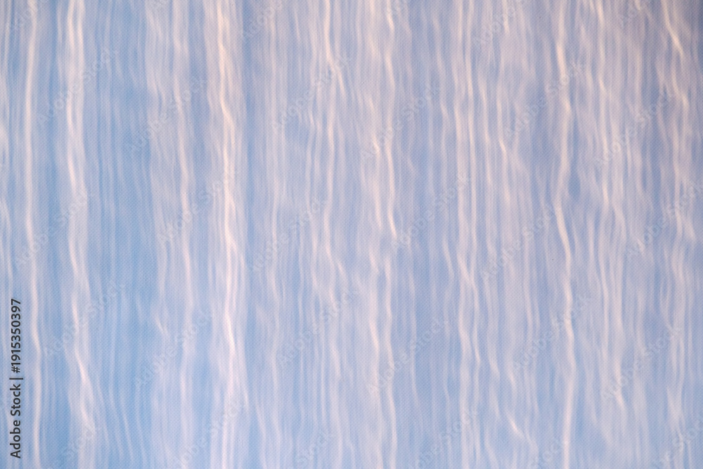 Obraz premium Blue abstract background texture with vertical wavy lines. Minimalist design. Light pattern for creative project.